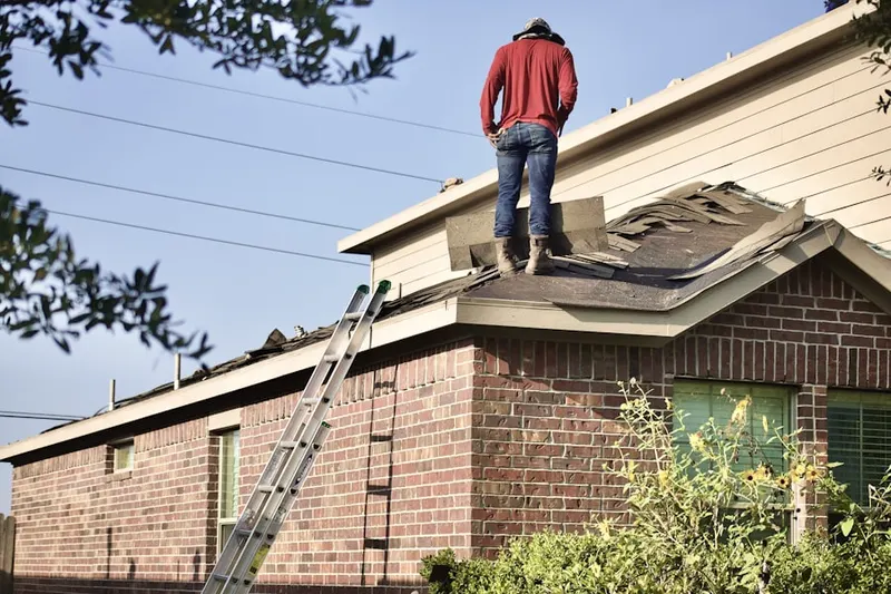 Professional roofer working on a residential roof in Yoakum